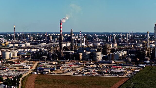 Aerial view of the Orlen Plock Production Plant with industrial chimneys, storage tanks, and complex infrastructure in Plock, Masovian Voivodeship, Poland.