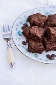 stack of chocolate gluten free brownie slices on plate at party