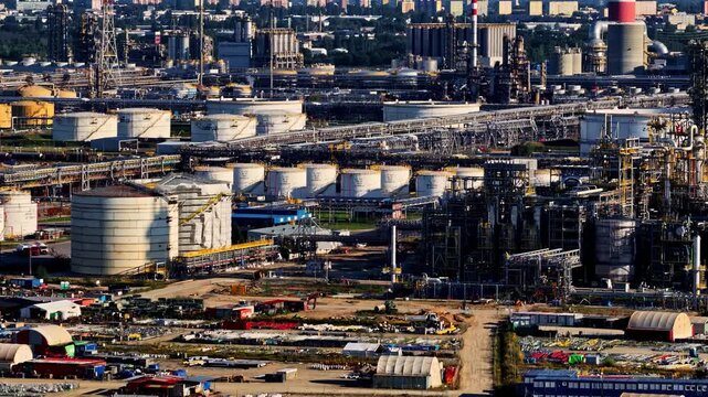 Aerial view of Orlen Plock Production Plant with large storage tanks, industrial infrastructure, and pipelines in Plock, Wojewodztwo mazowieckie, Poland.