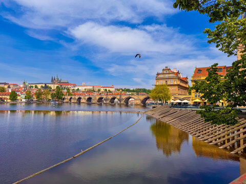 Prague riverside view with Charles Bridge and buildings in background