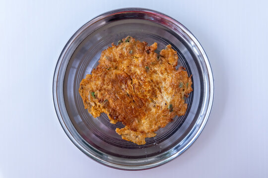Bangladeshi Style Fried Egg Omelette with Chili and Onion, Crispy Omelet Served on Metal Plate for Morning Breakfast. Top view.
