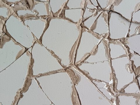 Abstract pattern of shattered broken ceramic floor tiles glued together forming geometric fracture lines texture for construction background.