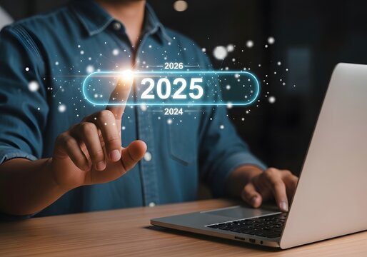 Person interacting with a digital interface to select the year 2025 on a laptop computer screen