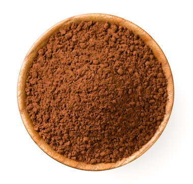 Raw cocoa powder in the wooden bowl, isolated on white background, top view.