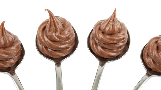 Four silver spoons topped with swirls of smooth creamy chocolate ganache or mousse on a white surface isolated on a transparent background