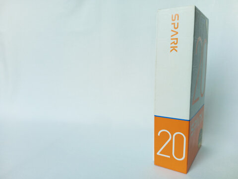 Tecno smartphone paper box package on white background. Side view of Spark 20 phone box. An Android phone with fingerprint and proximity sensor and dual flash. Kumasi, Ghana - December 9, 2025