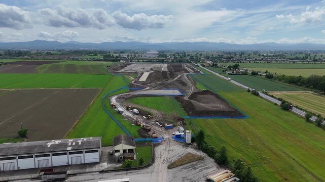 ASP-C01 Barabasca construction works reshape agricultural land near Fiorenzuola d'Arda, Piacenza, with graded soil, site roads and construction vehicles near the A1-A21 corridor, drone aerial shot.