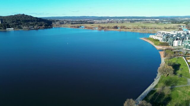Drone aerial landscape of the Kingston Foreshore East Basin with residential apartments and a lakeside pathway promenade along Lake Burley Griffin in Canberra ACT Australia tourism and infrastructure