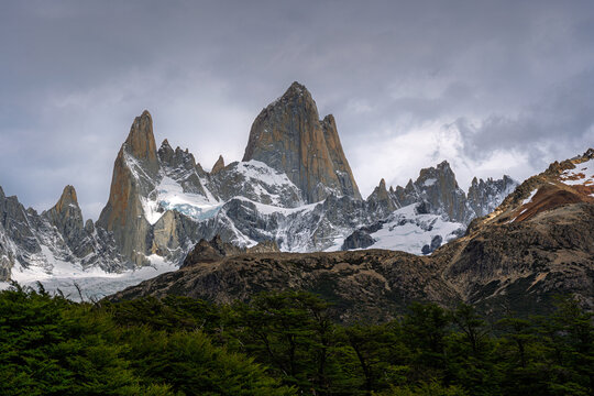 Granite spires of Mount Fitz Roy above southern beech forest under heavy cloud, Patagonia
