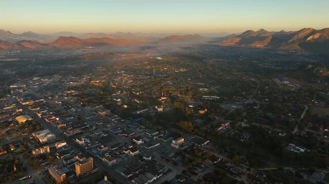 Sunrise aerial descends to quiet morning streets of Mutare, Zimbabwe