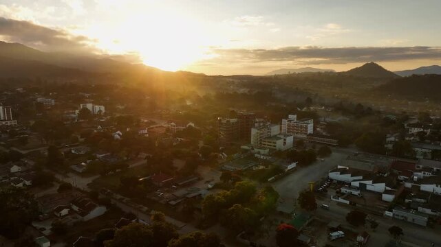 Sunrise aerial rotates over morning city streets of Mutare, Zimbabwe