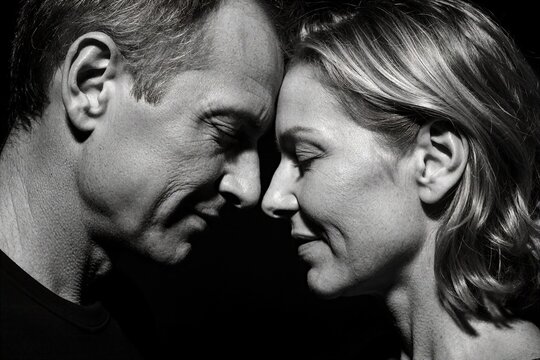 Black and white portrait of mature couple touching foreheads