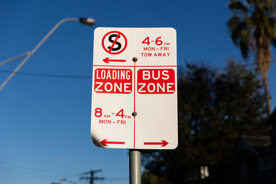 street sign with no standing, loading zone and bus zone
