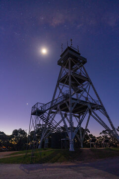 Moon shining over the steel observation tower