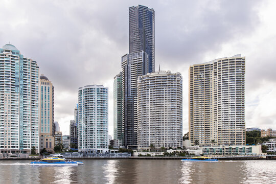 Brisbane city high rise buildings with ferries passing on the river in the foreground