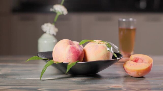 Fresh Peaches And Peach Tea With Cinematic Parallax Camera Movement.
Ripe fresh peaches arranged on a vintage table with a glass of peach tea softly out of focus in the background. Cinematic slider mo