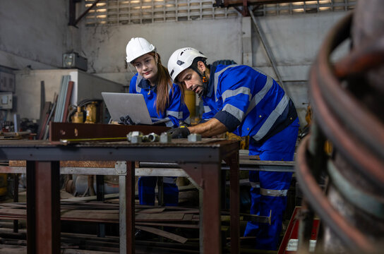 Team of industrial worker is measuring and checking the setup value of  machine while working inside automate factory for safety industry