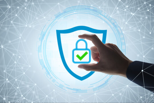 Cyber security and network data protection. Businessman placing padlock icon with checkmark on shield icon. Zero trust security architecture and user authentication system.