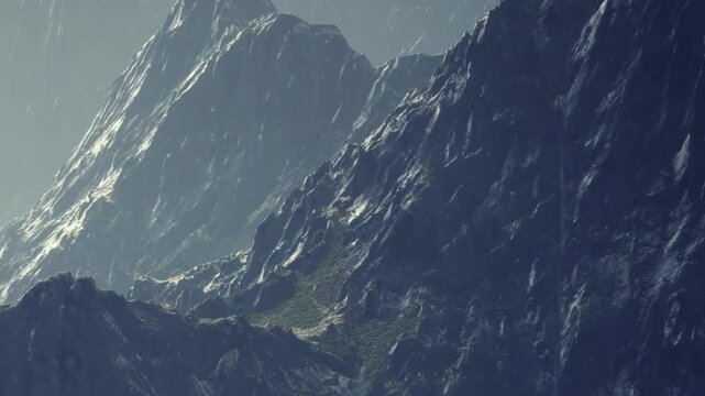 Rugged mountains are seen during the day. Sunlight hits the peaks, creating shadows and highlighting the rocky textures. The scenery shows a mixture of light and dark areas.