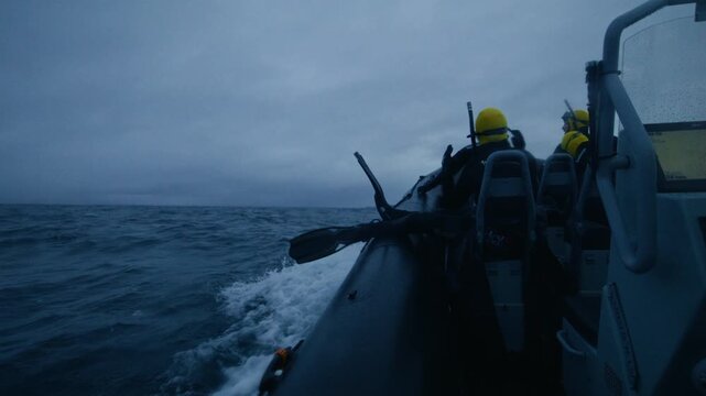 Divers aboard expedition boat crossing rough Arctic waters in Norway