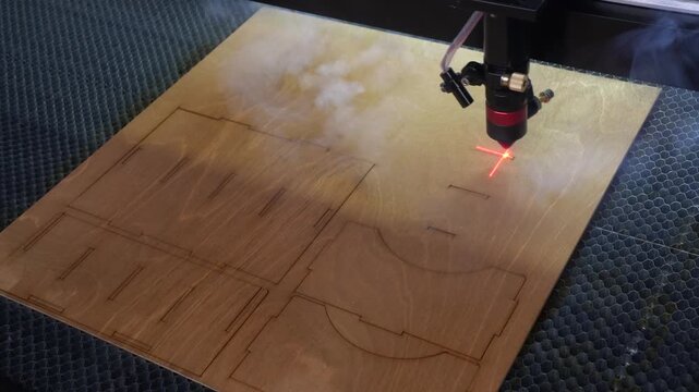 Laser cutting machine. The laser cuts the details. Automation and precision system. Modern industrial technology. Industrial laser engraving machine. Cnc laser head.