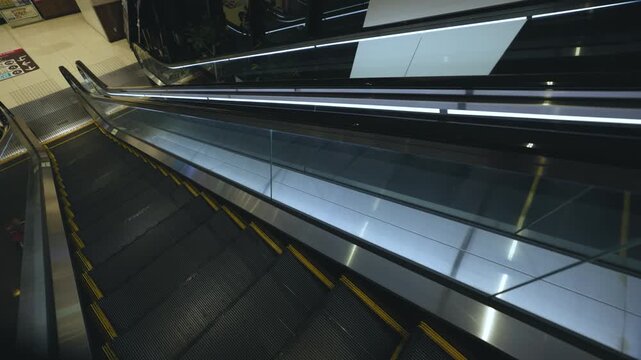 Pov heading down an empty escalator