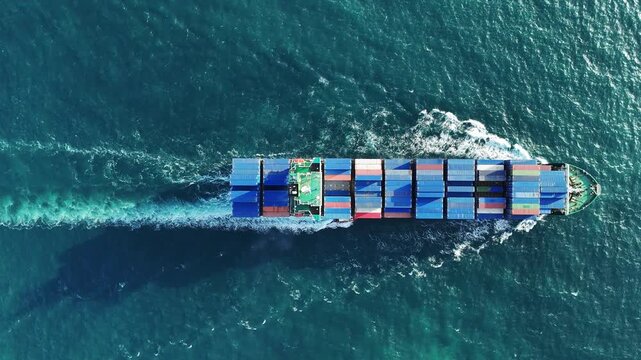 container ship fully loaded with colorful cargo sailing through the deep blue ocean water. Global maritime logistics, international shipping trade, and marine freight transport concept.