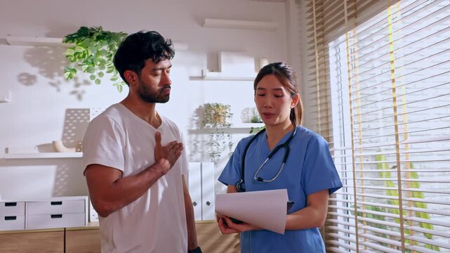 Doctor and patient discussing medical care during healthcare consultation with female worker bright clinic, professional conversation about symptoms, supportive communication and stethoscope