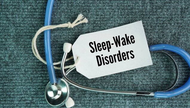 Stethoscope and paper tag with the words Sleep-Wake Disorders: Conditions involving major disruptions in regular sleep patterns and behaviors, such as severe insomnia