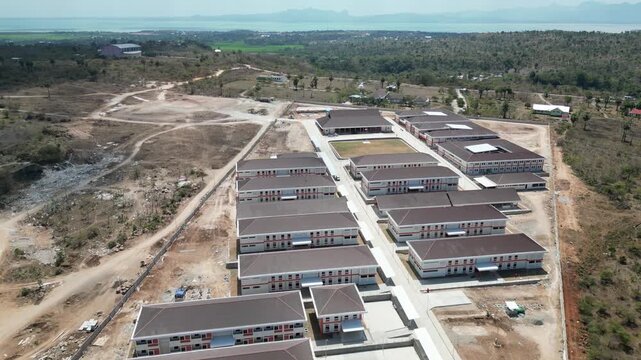 Aerial view of Sekolah Rakyat in Kupang, East Nusa Tenggara, Indonesia, with school buildings, dry land, and rural hills.
