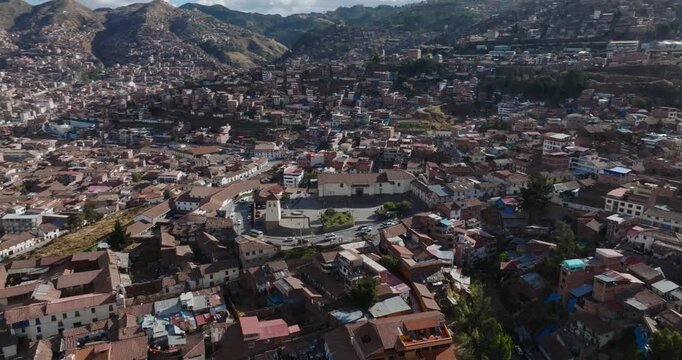 Aerial view of the historic city center of Cusco with its dense urban fabric, terracotta rooftops, and colonial architecture in Cusco, Cusco, Peru.