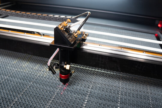 Laser cutting machine. The laser cuts the details. Automation and precision system. Modern industrial technology. Industrial laser engraving machine. Cnc laser head.
