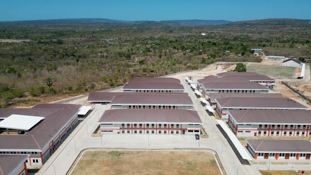Aerial view of Sekolah Rakyat in Kupang, East Nusa Tenggara, Indonesia, with school buildings, dry land, and rural hills.