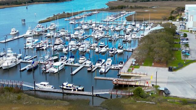 Aerial view of Morningstar Marinas Southport with numerous boats docked in the marina, surrounded by marshlands and coastal landscape in Southport, North Carolina, United States.