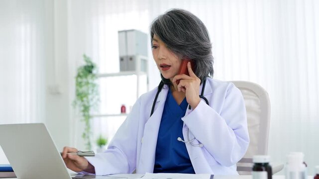 professional medical doctor talking on mobile phone in hospital.
