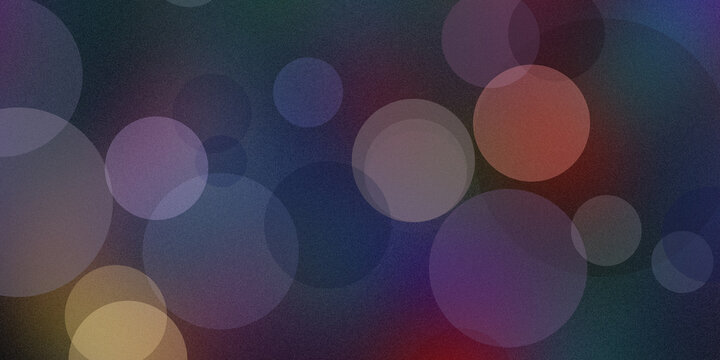 Abstract bokeh background featuring glowing circular light particles of orange purple and blue colors on dark backdrop.