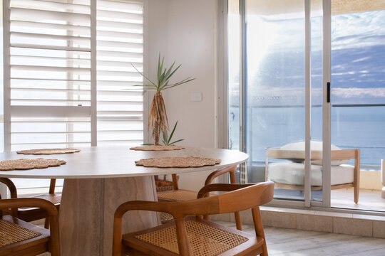 apartment interior, round dining table with an ocean view