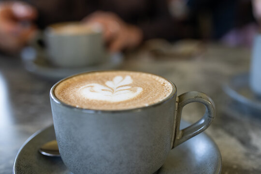 flat white coffee in a grey cup