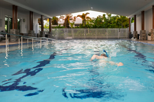 senior woman swimming laps