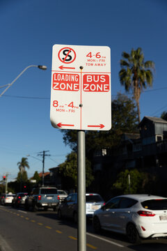 street signs for no standing, loading and bus zones at different times