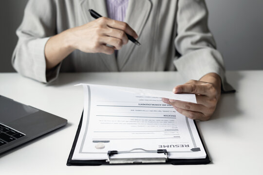 Businesswoman Reviewing Resumes for Recruitment and Hiring Candidates, Analyzing Applicant Information Before Job Interviews in Human Resources and Corporate Office