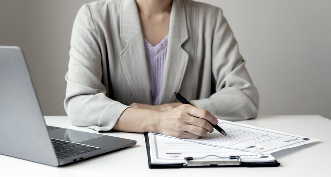 Businesswoman Reviewing Resumes for Recruitment and Hiring Candidates, Analyzing Applicant Information Before Job Interviews in Human Resources and Corporate Office