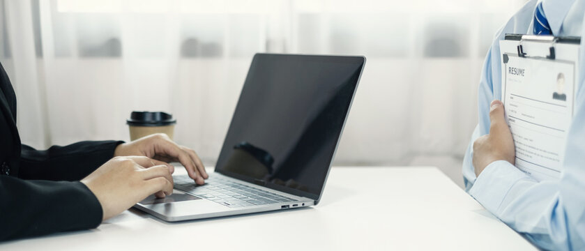 Business people hold a resume and talk to job applicants for job interviews about careers and Their personal history in the company. Recruitment concepts