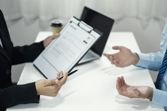 Business people hold a resume and talk to job applicants for job interviews about careers and Their personal history in the company. Recruitment concepts