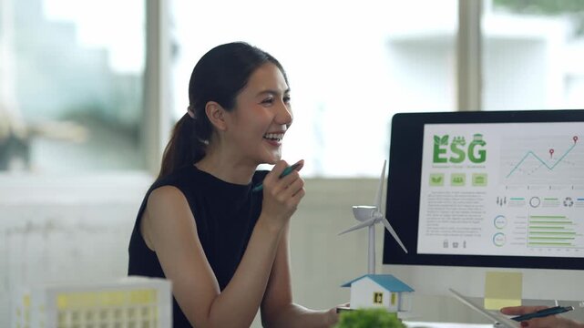 Businesswoman discussing ESG principles and renewable energy solutions with a colleague in a modern office meeting