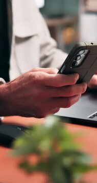 Hands, laptop and businessman scroll on mobile for record keeping, finance app and auditing. Tech, accountant or phone in office for financial reporting, budget review or MFA code for income tracking