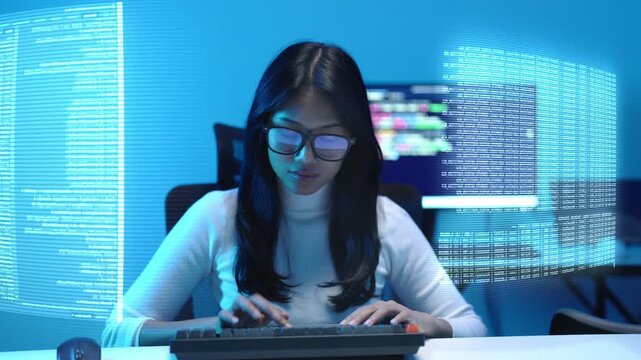 Front view of a woman data scientist in a dark blue office, typing on a keyboard as streams of code and analytics dashboards glow on holographic panels beside her.