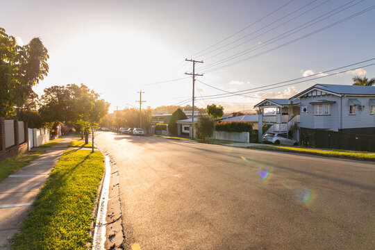 wide suburban street in golden afternoon light
