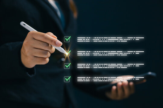 Business professional using a digital checklist interface with glowing check marks, representing task management, quality control, compliance, workflow, productivity, and online approval.