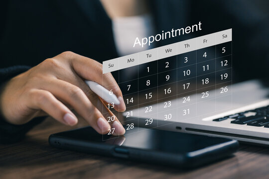Business professional scheduling an appointment on a digital calendar using laptop and smartphone, representing time management, planning, organization, productivity, and online booking.